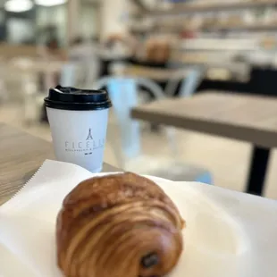 a croissant and a cup of coffee