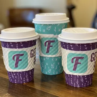 three cups of coffee on a table