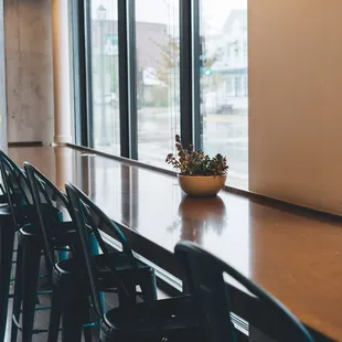 a wooden table with black chairs