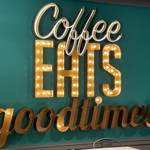 a sign that says coffee hits good times