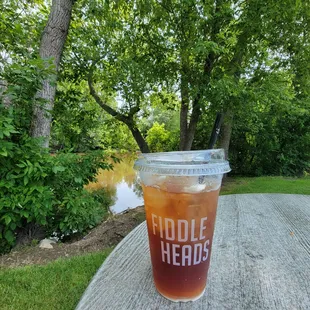 a cold drink on a picnic table