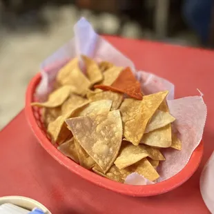 a bowl of chips and a bowl of salsa