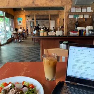 a plate of salad and a laptop on a table