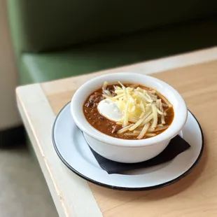 a bowl of chili and cheese
