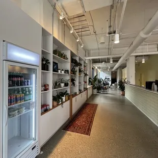 a long hallway with a refrigerator