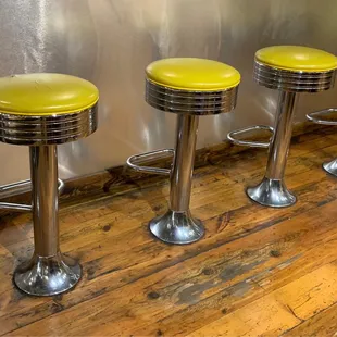 a row of stools in a kitchen