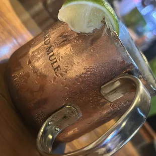 a copper mug with a lime wedge