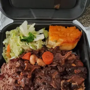 Large Oxtail dinner with cabbage, mac and cheese, and peas and rice.