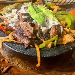 Molcajete   Steak, shrimp, Carnitas, chorizo, chicken, cactus, onions, bell peppers, queso fresco, avocado, lettuce, pico