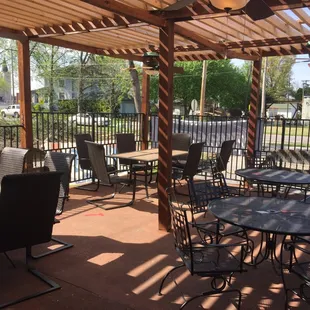a patio with tables and chairs
