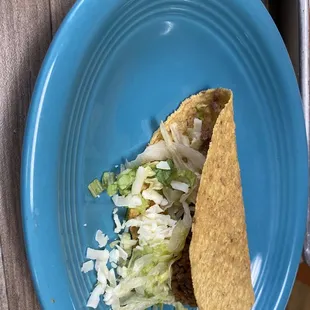 a blue plate with a taco on it