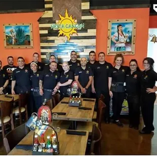 a group of people standing in a restaurant