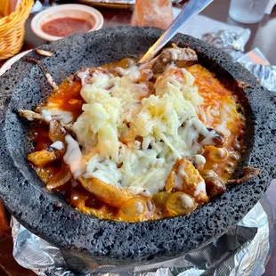 The Molcajete sizzling fresh right to your table. Steak, chicken, shrimp in a red sauce with peppers onions and topped with cheese.