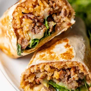 a burrito cut in half on a plate