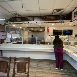 a woman standing at a counter