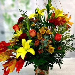 A custom $100 fall arrangement with preserved oak leaves.