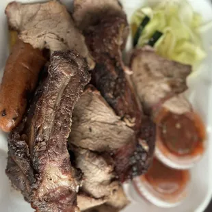BBQ beef rib, pork rib, tri tip, sausage and chicken quarter with salad.