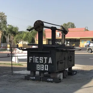 a black trash can on the side of the road