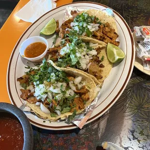 a plate of tacos and salsa