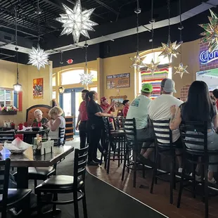 Servers ignore their tables and watch a horse race.