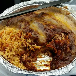 Delicious chicken enchiladas mole with refried beans &amp; rice.