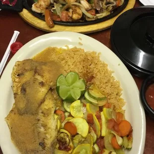 Shrimp fajitas (a sizzling beauty) and Catfish in homemade garlic sauce with vegetables and rice