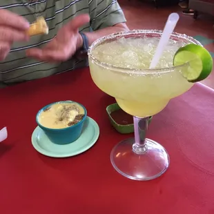 Large margarita and cheese dip with ground beef.