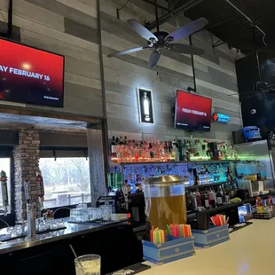 a view of a bar and televisions