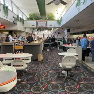 the inside of a restaurant with tables and chairs