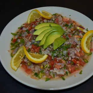 a bowl of salsa with avocado