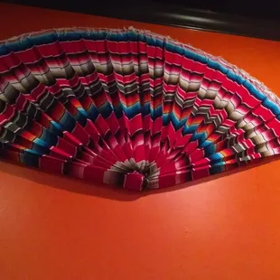 a colorful fan on the wall