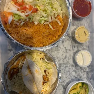 a tray of mexican food and condiments