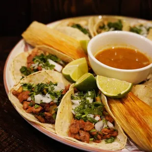 a plate of tacos and salsa