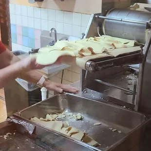 a woman making tortillas