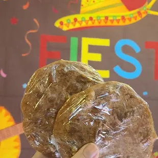 a hand holding a donut