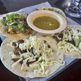 a plate of tacos and a drink