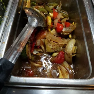 a spoon in a bowl of food