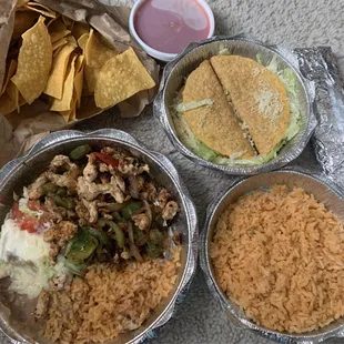 Lunch chicken fajita w/ sides, two beef tacos with rice, chips and salsa.