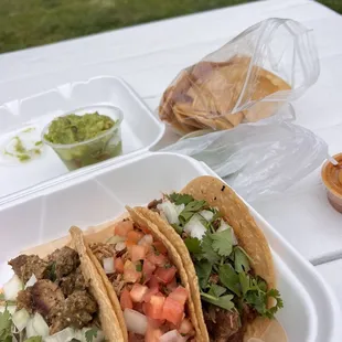 Pastor , chili verde, and carnita taco  With a side of chips and guacamole
