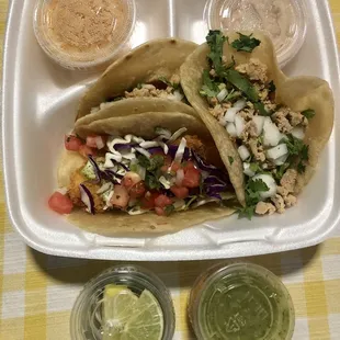 Delivery: Two chicken tacos and one shrimp taco with beans and rice.