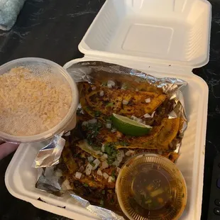 Quesabirria tacos with consommé and a side of Mexican rice