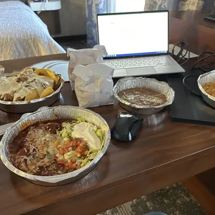 a table of food and a laptop