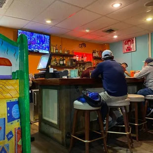 two men sitting at a bar