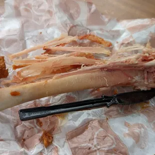 a bone of meat on a piece of wax paper