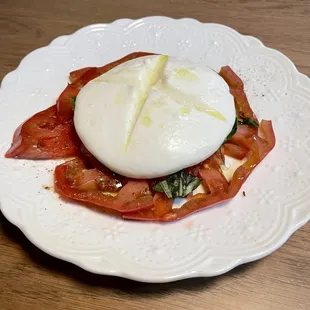 Homemade mozzarella with heirloom tomatoes, basil, and olive oil