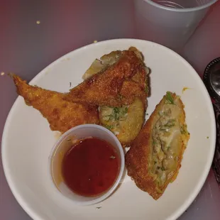 a plate of fried food and a cup of ketchup