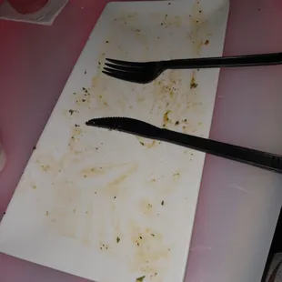 a dirty plate with a fork and knife on it