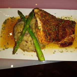 a plate of food with meat and asparagus