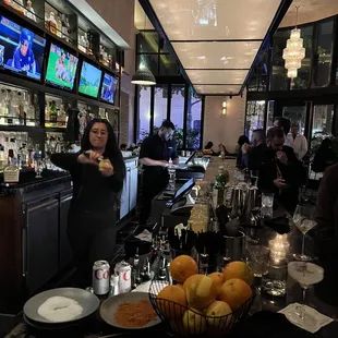 a woman standing at a bar