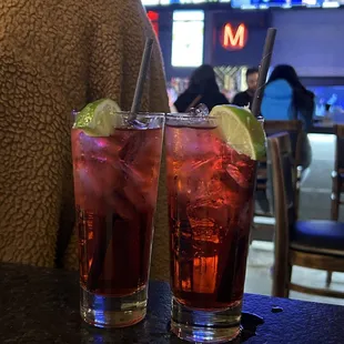 two glasses of drink on a table
